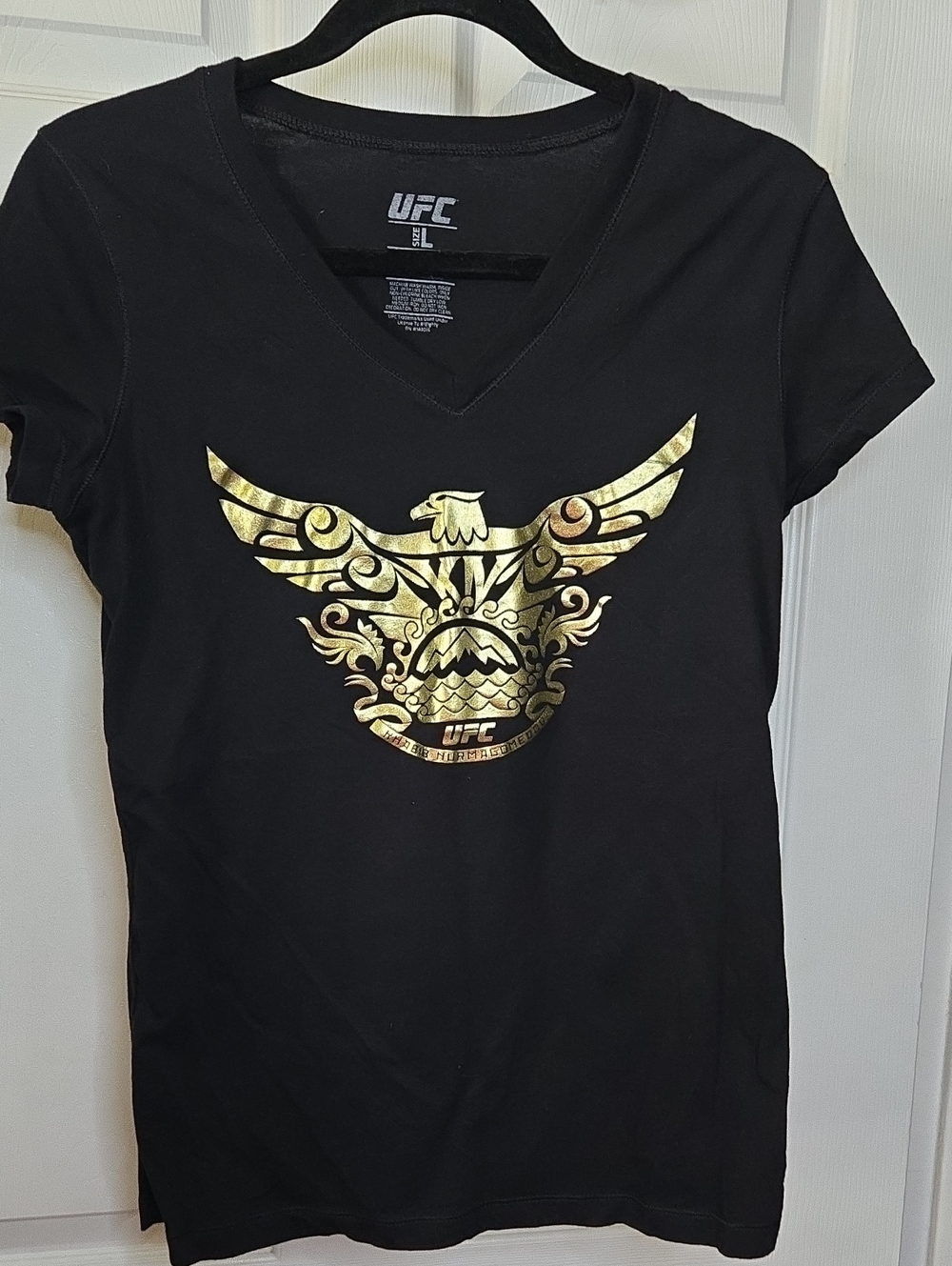 UFC Women's Black V-Neck Tee with Metallic Gold Eagle Emblem